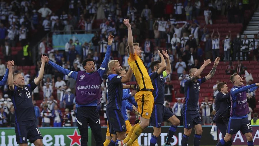 Finland's goalkeeper Lukas Hradecky punches the ball away from Denmark's Andreas Cornelius, center right, during the Euro 2020 soccer championship group B match between Denmark and Finland at Parken Stadium in Copenhagen, Saturday, June 12, 2021. (Stuart Franklin/Pool via AP)