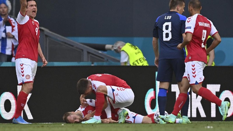 Finland's goalkeeper Lukas Hradecky punches the ball away from Denmark's Andreas Cornelius, center right, during the Euro 2020 soccer championship group B match between Denmark and Finland at Parken Stadium in Copenhagen, Saturday, June 12, 2021. (Stuart Franklin/Pool via AP)