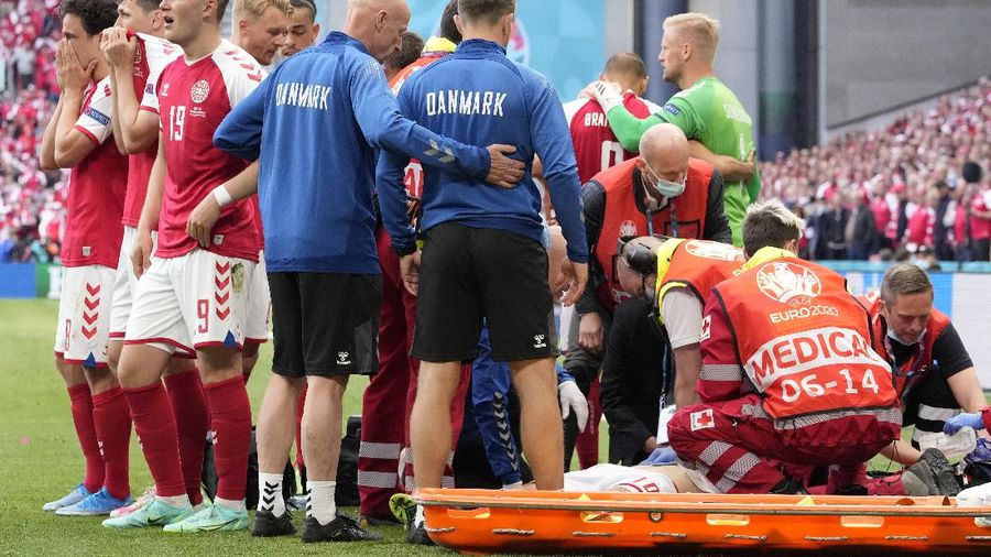 Finland's goalkeeper Lukas Hradecky punches the ball away from Denmark's Andreas Cornelius, center right, during the Euro 2020 soccer championship group B match between Denmark and Finland at Parken Stadium in Copenhagen, Saturday, June 12, 2021. (Stuart Franklin/Pool via AP)