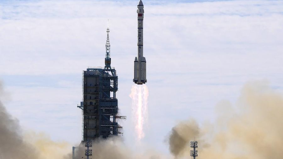 This photo released by Xinhua News Agency shows a screen at Beijing Aerospace Control Center showing astronaut Liu Boming stepping out of core module of the China's new space station in space on Sunday, July 4, 2021. Two astronauts made the first space walk on Sunday outside China's new orbital station to work on setting up a 15-meter (50-foot) long robotic arm. (Jin Liwang/Xinhua via AP)