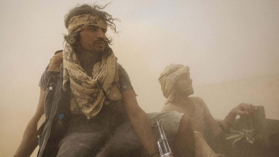 A Yemeni fighter backed by the Saudi-led coalition fires his weapon on the front lines of Marib, Yemen, Saturday, June 19, 2021. (AP Photo/Nariman El-Mofty)