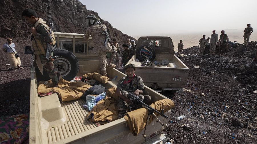 A Yemeni fighter backed by the Saudi-led coalition fires his weapon on the front lines of Marib, Yemen, Saturday, June 19, 2021. (AP Photo/Nariman El-Mofty)