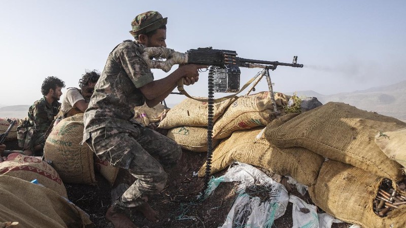 A Yemeni fighter backed by the Saudi-led coalition fires his weapon on the front lines of Marib, Yemen, Saturday, June 19, 2021. (AP Photo/Nariman El-Mofty)