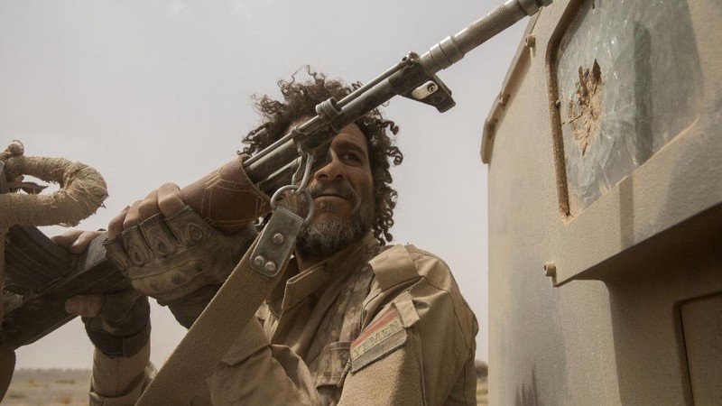 A Yemeni fighter backed by the Saudi-led coalition fires his weapon on the front lines of Marib, Yemen, Saturday, June 19, 2021. (AP Photo/Nariman El-Mofty)