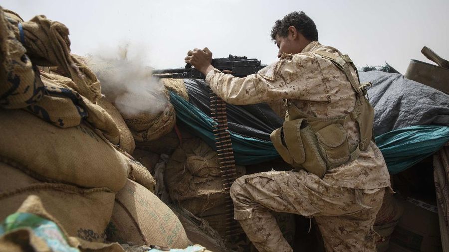 A Yemeni fighter backed by the Saudi-led coalition fires his weapon on the front lines of Marib, Yemen, Saturday, June 19, 2021. (AP Photo/Nariman El-Mofty)