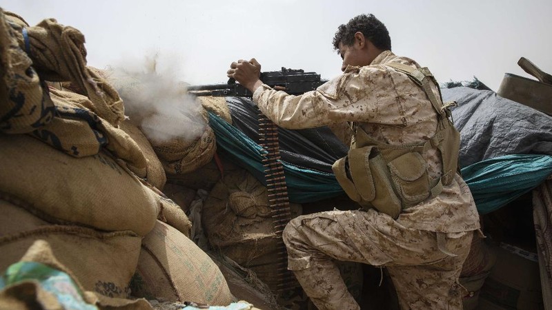 A Yemeni fighter backed by the Saudi-led coalition fires his weapon on the front lines of Marib, Yemen, Saturday, June 19, 2021. (AP Photo/Nariman El-Mofty)