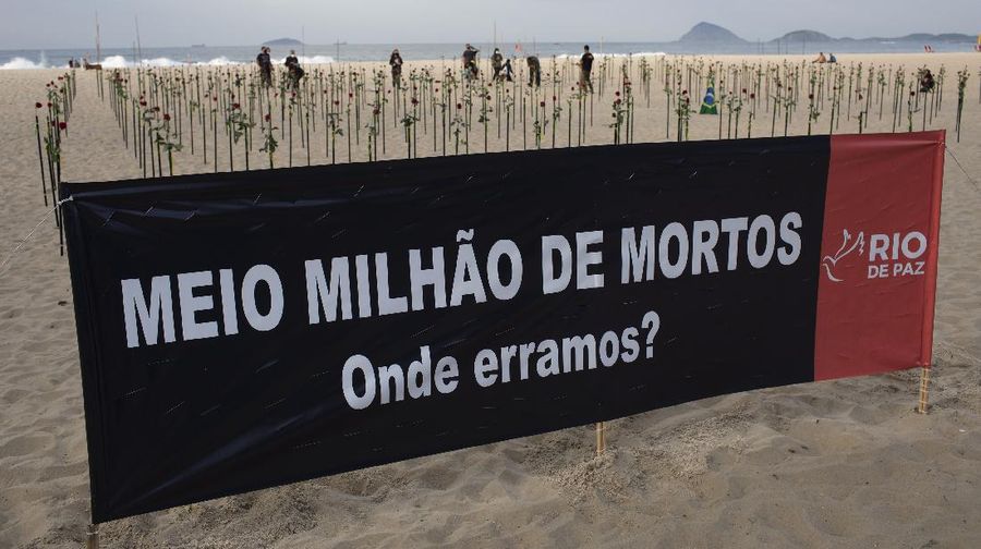 Roses are placed on Copacabana beach to honor the 500,000 COVID-19 deaths and to protest against Brazilian President Jair Bolsonaro and his handling of the COVID-19 pandemic, in Rio de Janeiro, Brazil, Sunday, June 20, 2021. Brazil's COVID-19 death toll surpassed the milestone of 500,000 deaths on Saturday night. (AP Photo/Silvia Izquierdo)