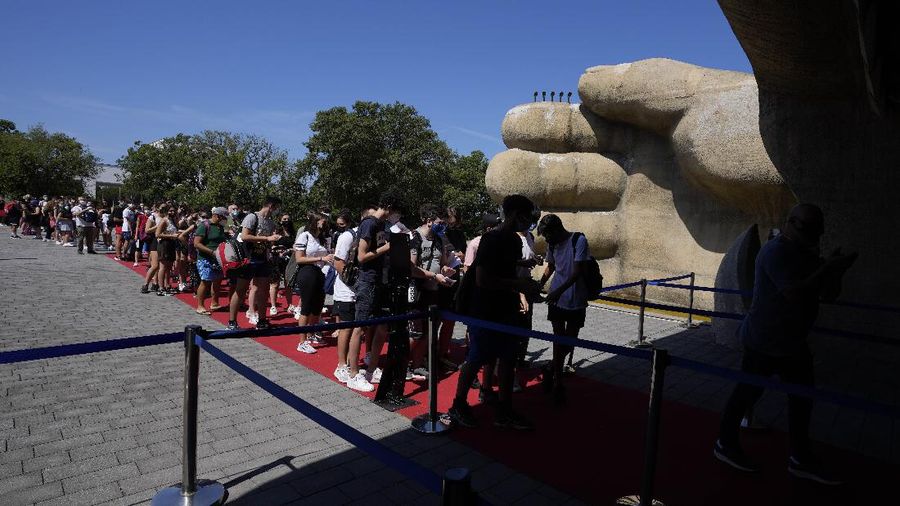 Visitors ride a roller coaster at Cinecitta World amusement park in the outskirts of Rome in the day of its reopening, Thursday, June 17, 2021. Amusement parks have been closed since Oct. 25 2020, when Italy's second national lockdown started. (AP Photo/Alessandra Tarantino)