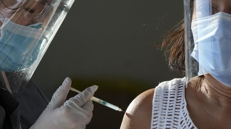 A health worker inoculates a woman with China's Sinovac COVID-19 vaccine at a temporary vaccination center in Manila, Philippines, Tuesday, June 22, 2021. The Philippine president has threatened to order the arrest of Filipinos who refuse COVID-19 vaccination and told them to leave the country for hard-hit countries like India and the United States if they would not cooperate with massive efforts to end the pandemic. (AP Photo/Aaron Favila)