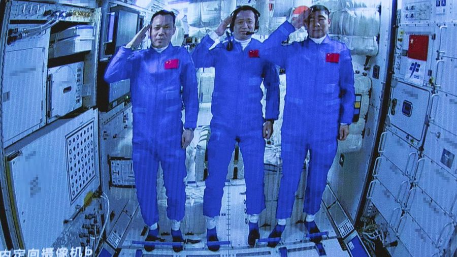 In this photo released by Xinhua News Agency, Chinese astronauts salute after successfully entering the Tianhe space station module as they are displayed on a big screen at the Beijing Aerospace Control Center in Beijing, on Thursday, June 17, 2021. China has launched the first three-man crew to its new space station in its the ambitious programs first crewed mission in five years (Jin Liwang/Xinhua via AP)
