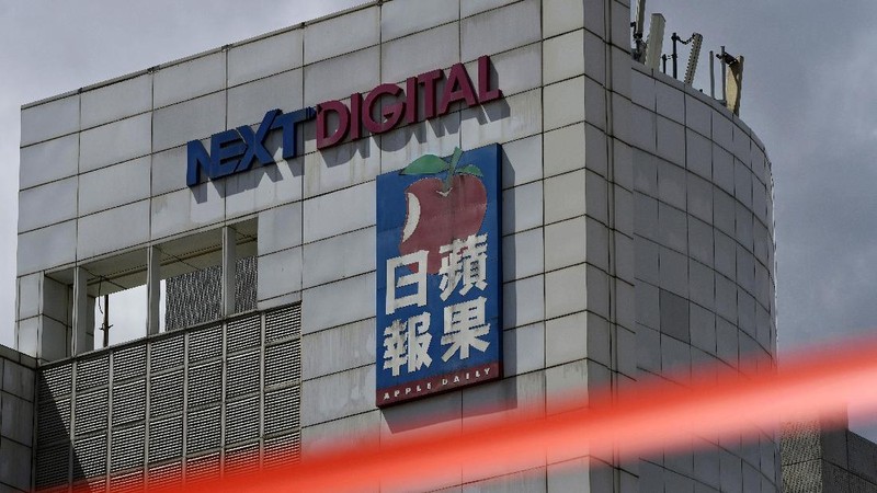 FILE - In this Thursday, June 17, 2021, file photo, a police cordon line is strung outside the Apple Daily headquarters in Hong Kong. Hong Kong’s pro-democracy Apple Daily newspaper will close by this weekend, its parent company said Wednesday, June 23, 2021, following last week’s arrest of five editors and executives and the freezing of $2.3 million in assets under the city’s national security law. (AP Photo/Kin Cheung, File)