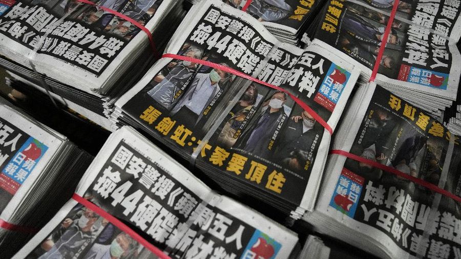 FILE - In this Thursday, June 17, 2021, file photo, a police cordon line is strung outside the Apple Daily headquarters in Hong Kong. Hong Kong’s pro-democracy Apple Daily newspaper will close by this weekend, its parent company said Wednesday, June 23, 2021, following last week’s arrest of five editors and executives and the freezing of $2.3 million in assets under the city’s national security law. (AP Photo/Kin Cheung, File)