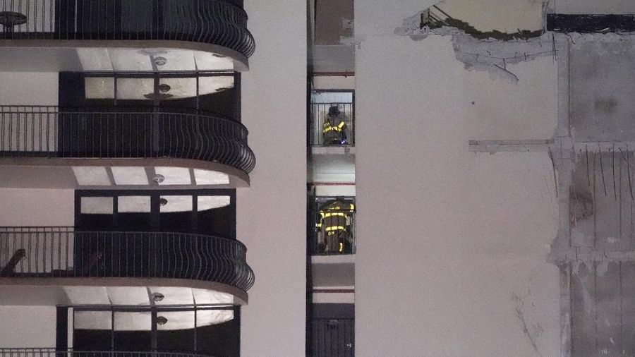 A partially collapsed building is seen early Thursday, June 24, 2021, in the Surfside area of Miami, Fla. A partial building collapse in Miami caused a massive response early Thursday from Miami Dade Fire Rescue, according to a tweet from the department's account. Miami Dade Fire Rescue is conducting search and rescue. Authorities had no word yet on casualties, or details of how many people lived in the building. (AP Photo/Wilfredo Lee)