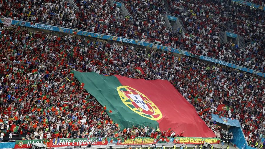 Portugal supporters unfurl a large flag before the Euro 2020 soccer championship group F match between Portugal and France at the Ferenc Puskas stadium in Budapest, Hungary, Wednesday, June 23, 2021. (AP Photo/Laszlo Balogh, Pool)