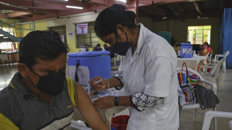 A health worker prepares to administer the Covishield vaccine to a person during a special vaccination drive against COVID-19 at a vegetable market in Hyderabad, India, Thursday, June 24, 2021. (AP Photo/Mahesh Kumar A.)