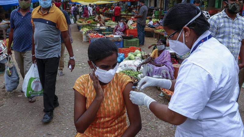 A health worker prepares to administer the Covishield vaccine to a person during a special vaccination drive against COVID-19 at a vegetable market in Hyderabad, India, Thursday, June 24, 2021. (AP Photo/Mahesh Kumar A.)