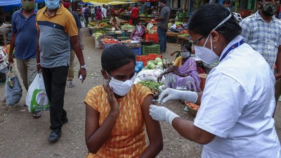 Virus Outbreak India A health worker prepares to administer the Covishield vaccine to a person during a special vaccination drive against COVID-19 at a vegetable market in Hyderabad, India, Thursday, June 24, 2021. (AP Photo/Mahesh Kumar A.)