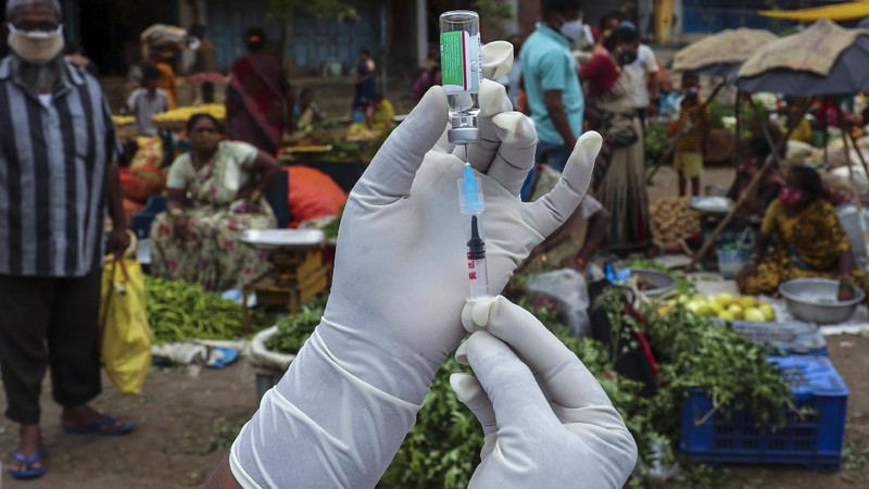 A health worker prepares to administer the Covishield vaccine to a person during a special vaccination drive against COVID-19 at a vegetable market in Hyderabad, India, Thursday, June 24, 2021. (AP Photo/Mahesh Kumar A.)