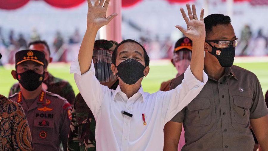 People line up to get vaccinated with the Sinovac COVID-19 vaccine during a mass vaccination at Gelora Bung Karno Main Stadium in Jakarta, Indonesia, Saturday, June 26, 2021. The world's fourth most populous country, has seen COVID-19 infections surge in recent weeks, putting pressure on hospitals, including in the capital city, where most of hospital beds are full, and has added urgency to the government's plan to inoculate 1 million people each day by next month. (AP Photo/Dita Alangkara)