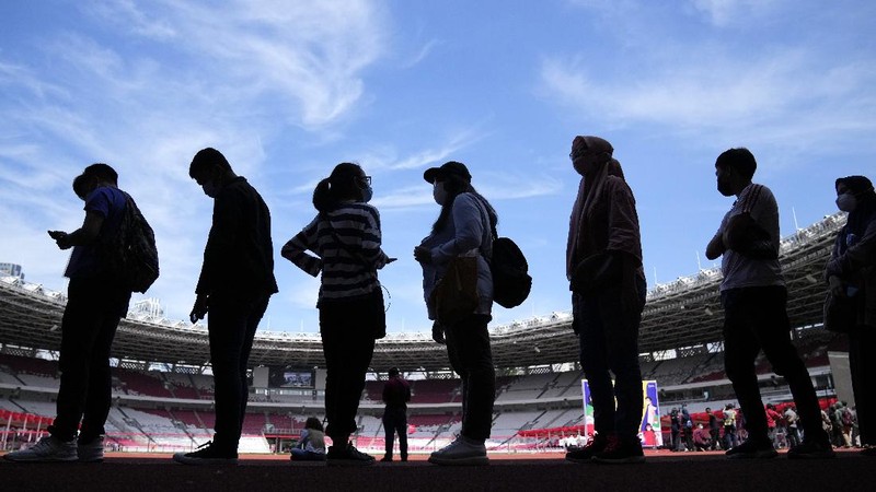 People line up to get vaccinated with the Sinovac COVID-19 vaccine during a mass vaccination at Gelora Bung Karno Main Stadium in Jakarta, Indonesia, Saturday, June 26, 2021. The world's fourth most populous country, has seen COVID-19 infections surge in recent weeks, putting pressure on hospitals, including in the capital city, where most of hospital beds are full, and has added urgency to the government's plan to inoculate 1 million people each day by next month. (AP Photo/Dita Alangkara)
