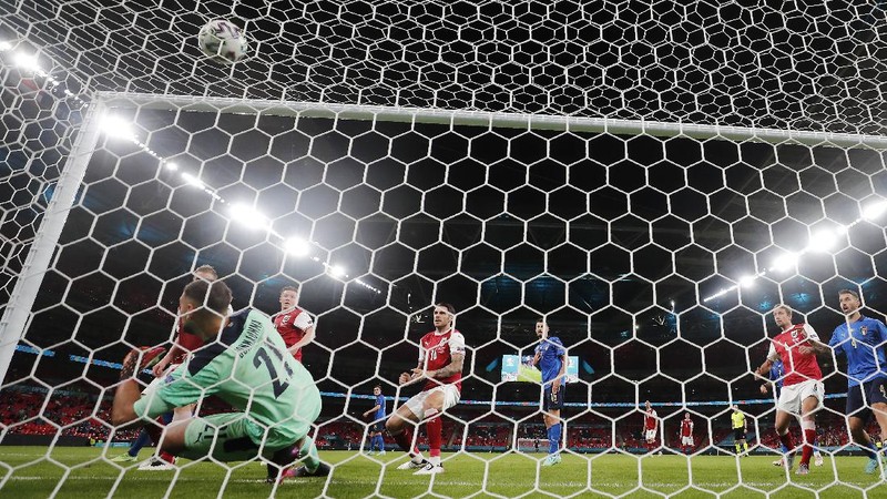 Denmark's Martin Braithwaite, centre, makes an attempt to score during the Euro 2020 soccer championship round of 16 match between Wales and Denmark at Johan Cruyff ArenA in Amsterdam, Netherlands, Saturday, June 26, 2021. (Olaf Kraak/Pool via AP)
