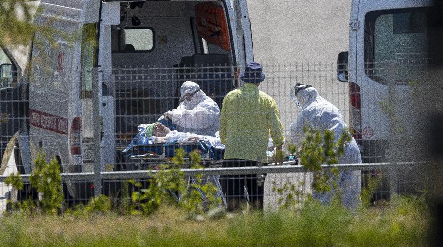 Medical workers carry a patient suspected of having coronavirus on a stretcher at a hospital in Kommunarka, outside Moscow, Russia, Saturday, June 26, 2021. Russia on Saturday reported its highest daily COVID-19 death toll of the year as the country grapples with a sharp spike in infections that has brought new restrictions in some regions. The national coronavirus task force said 619 people died over the past day, the most since Dec. 24. There were were 21,665 new infection cases, nearly 1,300 more than on the previous day and more than double the 9,500 reported on June 1. (AP Photo/Alexander Zemlianichenko)