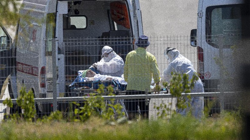 Medical workers carry a patient suspected of having coronavirus on a stretcher at a hospital in Kommunarka, outside Moscow, Russia, Saturday, June 26, 2021. Russia on Saturday reported its highest daily COVID-19 death toll of the year as the country grapples with a sharp spike in infections that has brought new restrictions in some regions. The national coronavirus task force said 619 people died over the past day, the most since Dec. 24. There were were 21,665 new infection cases, nearly 1,300 more than on the previous day and more than double the 9,500 reported on June 1. (AP Photo/Alexander Zemlianichenko)
