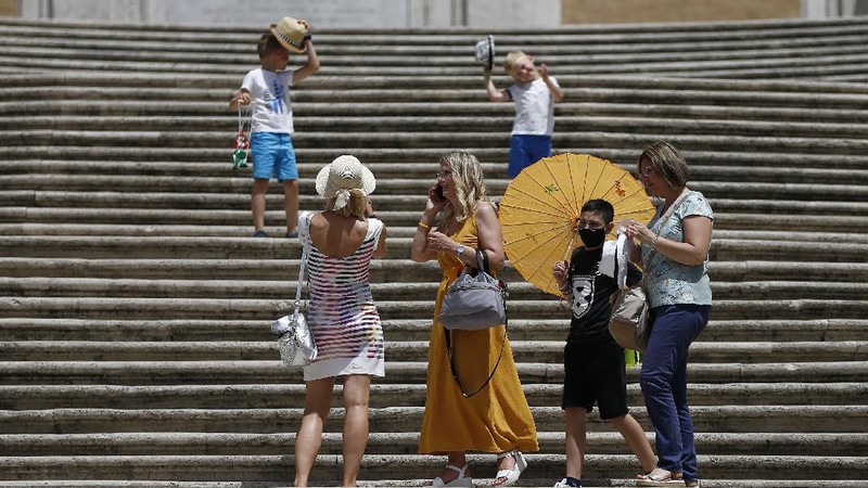 People gather and walk in front of the Trevi fountain in Rome, Monday, June 28, 2021. Italians took off their face masks and breathed a huge sigh of relief on Monday as the government-imposed requirement on mask wearing outdoors was lifted. Italian Health Minister Roberto Speranza made the decision last week to lift the outdoor mask-wearing requirement on advice from Italy’s Scientific Technical Committee (CTS) that made the decision based on the stabilisation of Italy Covid-19 indicators. (Cecilia Fabiano/LaPresse via AP)