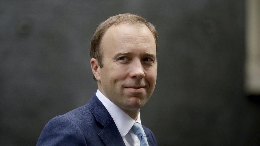 FILE - In this Wednesday, Sept. 16, 2020 file photo, British Health Secretary Matt Hancock walks from 10 Downing Street in London. Britain’s health minister has apologized for breaching social distancing rules after a newspaper ran pictures of him embracing a woman with whom he allegedly had an affair. Health Secretary Matt Hancock said in a statement that “I accept that I breached the social distancing guidance in these circumstances.