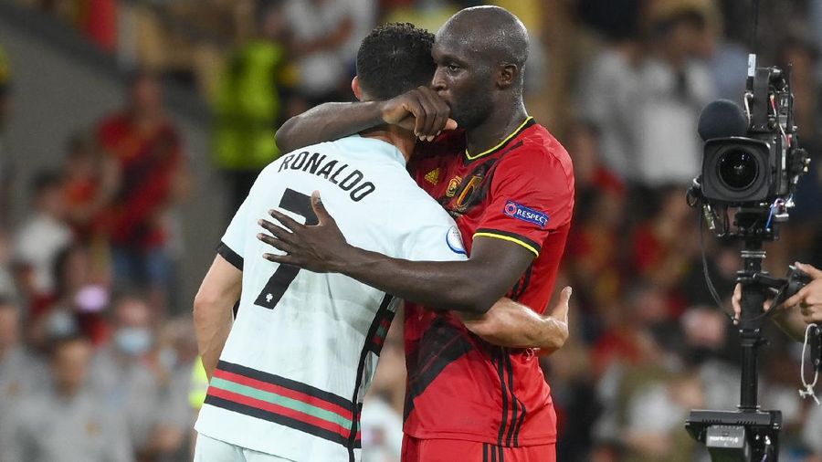 Portugal's Cristiano Ronaldo, right, reacts as Belgium players celebrate following the Euro 2020 soccer championship round of 16 match between Belgium and Portugal at La Cartuja stadium, Seville, Spain, Sunday, June 27, 2021. (Lluis Gene/Pool Photo via AP)