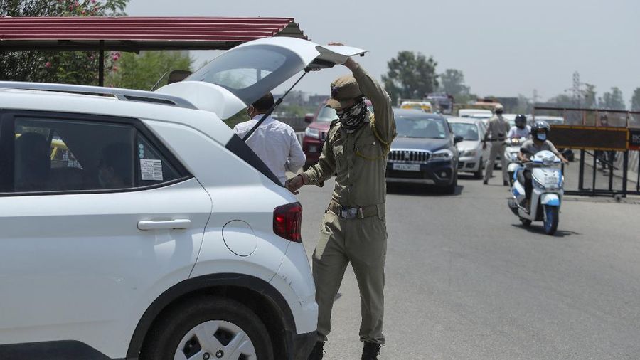 Security personnel check vehicles on the Jammu-Pathankot highway after troops around midnight spotted two drones separately flying over Kaluchak military base on the outskirts of Jammu, India, Monday, June 28, 2021. India's military said it thwarted a major threat when it intercepted two drones flying over an army base in Indian-controlled Kashmir early Monday, a day after suspected explosives-laden drones were used to attack an air base in the disputed region. (AP Photo/Channi Anand)