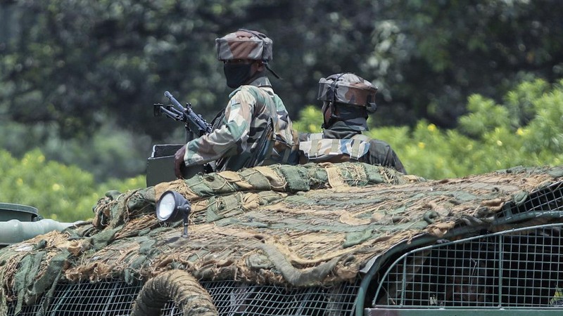 Security personnel check vehicles on the Jammu-Pathankot highway after troops around midnight spotted two drones separately flying over Kaluchak military base on the outskirts of Jammu, India, Monday, June 28, 2021. India's military said it thwarted a major threat when it intercepted two drones flying over an army base in Indian-controlled Kashmir early Monday, a day after suspected explosives-laden drones were used to attack an air base in the disputed region. (AP Photo/Channi Anand)