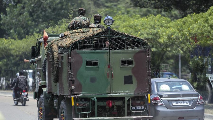 Security personnel check vehicles on the Jammu-Pathankot highway after troops around midnight spotted two drones separately flying over Kaluchak military base on the outskirts of Jammu, India, Monday, June 28, 2021. India's military said it thwarted a major threat when it intercepted two drones flying over an army base in Indian-controlled Kashmir early Monday, a day after suspected explosives-laden drones were used to attack an air base in the disputed region. (AP Photo/Channi Anand)