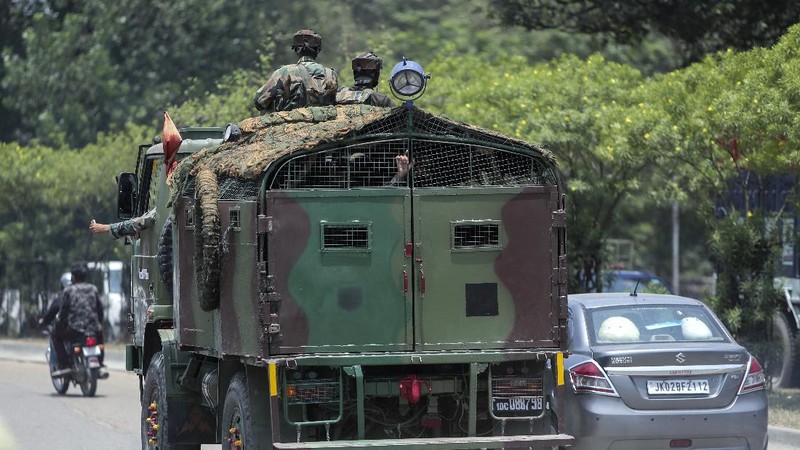 Security personnel check vehicles on the Jammu-Pathankot highway after troops around midnight spotted two drones separately flying over Kaluchak military base on the outskirts of Jammu, India, Monday, June 28, 2021. India's military said it thwarted a major threat when it intercepted two drones flying over an army base in Indian-controlled Kashmir early Monday, a day after suspected explosives-laden drones were used to attack an air base in the disputed region. (AP Photo/Channi Anand)