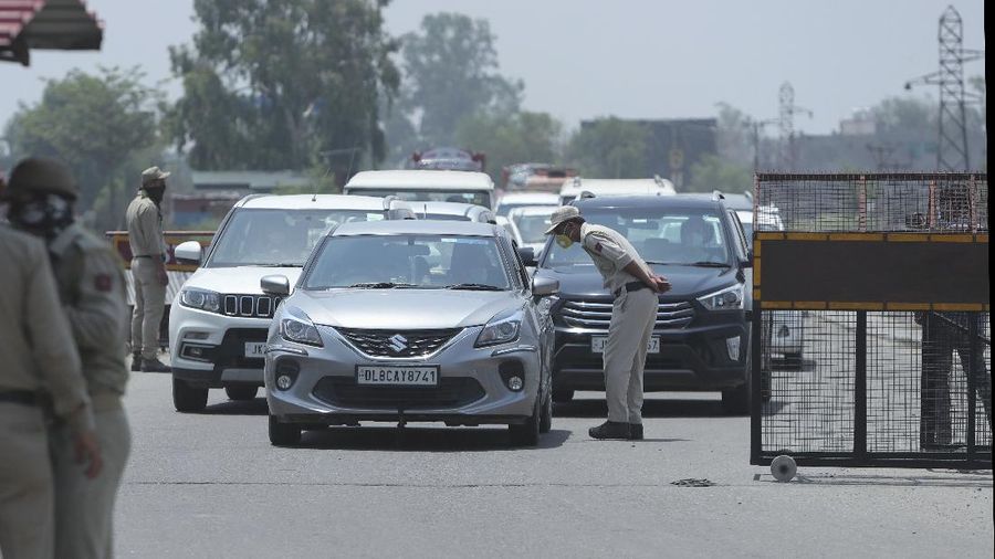 Security personnel stop vehicles for checking on the Jammu-Pathankot highway after troops around midnight spotted two drones separately flying over Kaluchak military base on the outskirts of Jammu, India, Monday, June 28, 2021. India's military said it thwarted a major threat when it intercepted two drones flying over an army base in Indian-controlled Kashmir early Monday, a day after suspected explosives-laden drones were used to attack an air base in the disputed region. (AP Photo/Channi Anand)
