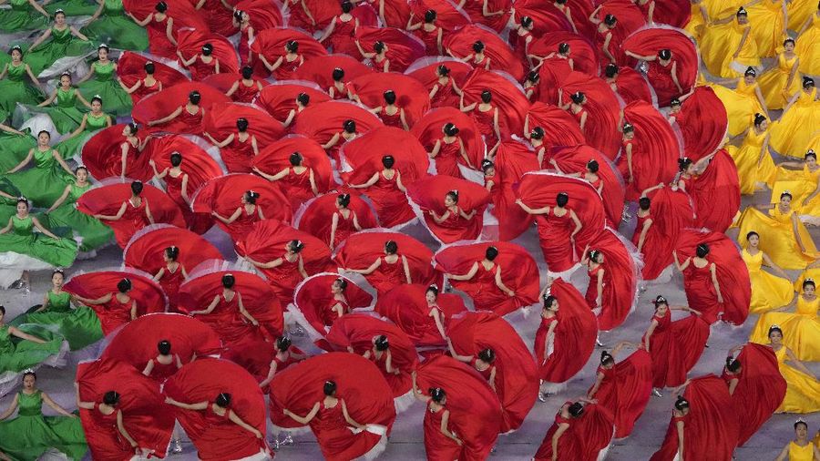 Performers dressed as rescue workers gather around the Communist Party flag during a gala show ahead of the 100th anniversary of the founding of the Chinese Communist Party in Beijing on Monday, June 28, 2021. China is marking the centenary of its ruling Communist Party this week by heralding what it says is its growing influence abroad, along with success in battling corruption at home. (AP Photo/Ng Han Guan)