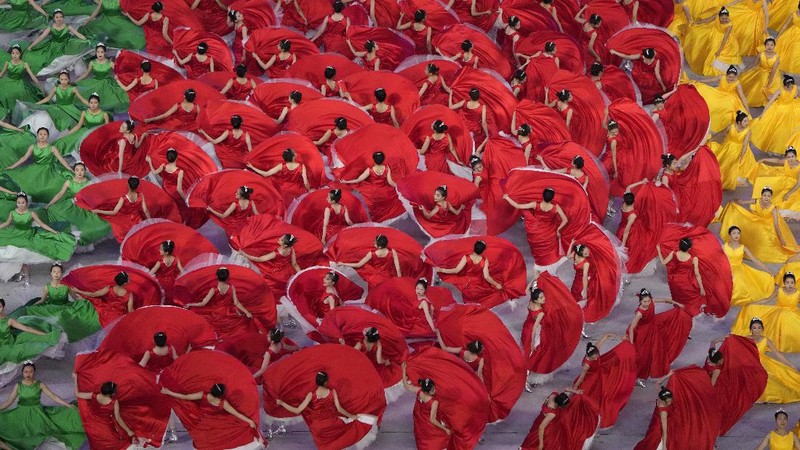 Performers dressed as rescue workers gather around the Communist Party flag during a gala show ahead of the 100th anniversary of the founding of the Chinese Communist Party in Beijing on Monday, June 28, 2021. China is marking the centenary of its ruling Communist Party this week by heralding what it says is its growing influence abroad, along with success in battling corruption at home. (AP Photo/Ng Han Guan)
