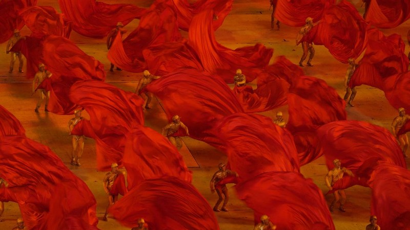 Performers dressed as rescue workers gather around the Communist Party flag during a gala show ahead of the 100th anniversary of the founding of the Chinese Communist Party in Beijing on Monday, June 28, 2021. China is marking the centenary of its ruling Communist Party this week by heralding what it says is its growing influence abroad, along with success in battling corruption at home. (AP Photo/Ng Han Guan)