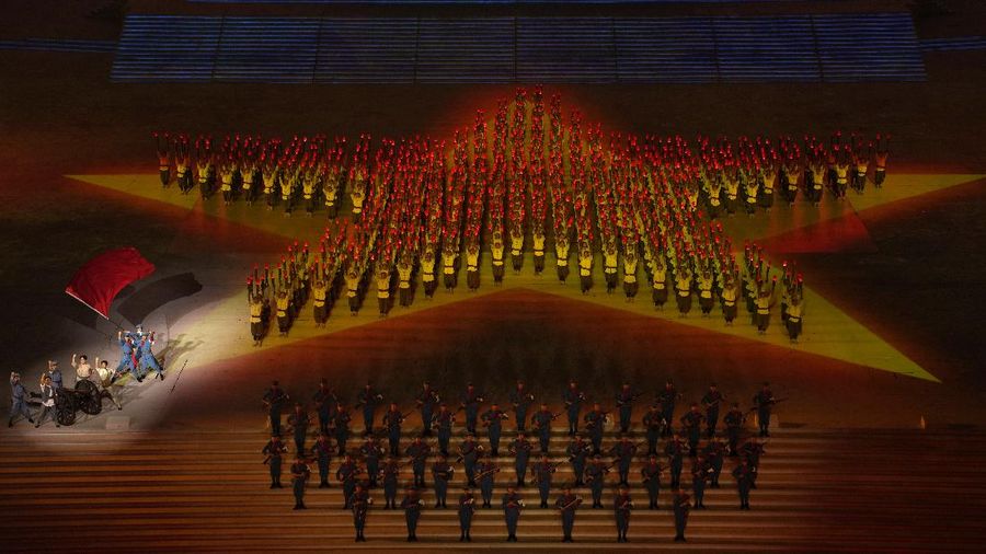 Chinese President Xi Jinping is displayed on a screen as performers dance at a gala show ahead of the 100th anniversary of the founding of the Chinese Communist Party in Beijing on Monday, June 28, 2021. China is marking the centenary of its ruling Communist Party this week by heralding what it says is its growing influence abroad, along with success in battling corruption at home. Party officials on Monday heaped praise on President Xi Jinping, who has established himself as China's most powerful leader since Mao Zedong, and has eliminated any limits on his term in office. (AP Photo/Ng Han Guan)