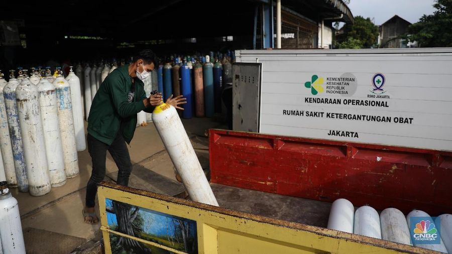Pekerja menata tabung oksigen di tempat pengisian oksigen PT Aneka Gas Industri, Cakung, Jakarta Timur, Rabu (30/6/2021). Pemprov DKI Jakarta mengerahkan kendaraan dari berbagai Satuan Kerja Perangkat Daerah (SKPD) atau kedinasan di DKI Jakarta untuk membantu mendistribusikan oksigen ke berbagai Rumah Sakit rujukan Covid-19.  Hal tersebut dilakukan untuk mempercepat sirkulasi tabung oksigen yang sempat mengalami kelangkaan beberapa hari lalu. Pantauan CNBC Indonesia beberapa truk dari perangkat daerah seperti Dishub DKI hingga SDA ikut mengantri mengambil oksigen. Antrian pengisian dilokasi tersebut juga memakan waktu lama. Salah satu sopir truk mengaku ia mengantri dari jam 7 pagi hingga pukul 15.30 belum juga bisa diangkut. Karena antrian truk yang begitu ramai. Tempat pengisian Oksigen ini melayani hingga 24 jam.  (CNBC Indonesia/ Muhammad Sabki)