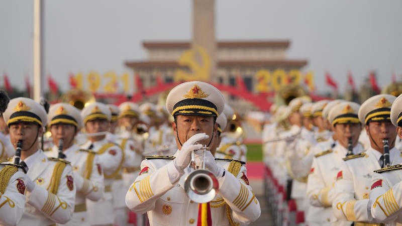 Performers dressed as rescue workers gather around the Communist Party flag during a gala show ahead of the 100th anniversary of the founding of the Chinese Communist Party in Beijing on Monday, June 28, 2021. China is marking the centenary of its ruling Communist Party this week by heralding what it says is its growing influence abroad, along with success in battling corruption at home. (AP Photo/Ng Han Guan)