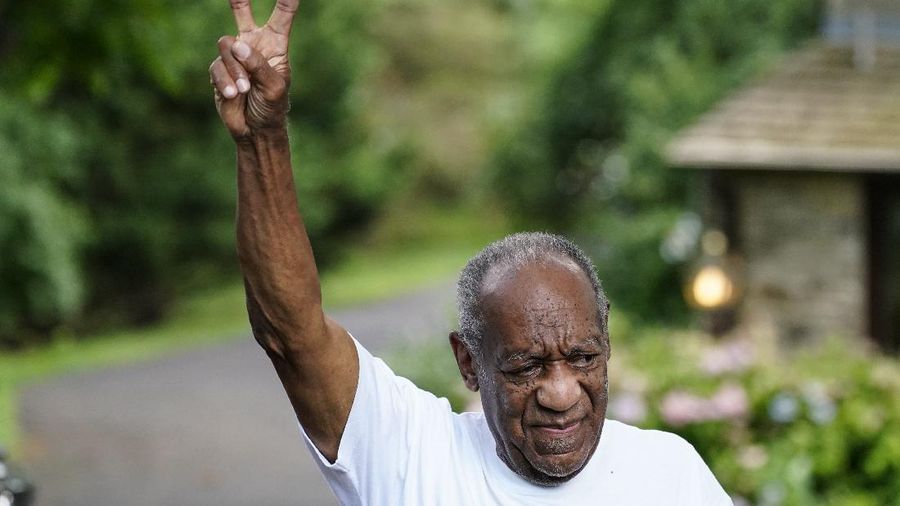Bill Cosby gestures outside his home in Elkins Park, Pa., Wednesday, June 30, 2021, after being released from prison. Pennsylvania's highest court has overturned comedian Cosby's sex assault conviction. The court said Wednesday, that they found an agreement with a previous prosecutor prevented him from being charged in the case. The 83-year-old Cosby had served more than two years at the state prison near Philadelphia and was released.(AP Photo/Matt Rourke)