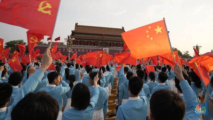 Chinese flags are waved during a rehearsal for a ceremony to mark the 100th anniversary of the founding of the ruling Chinese Communist Party at Tiananmen Gate in Beijing Thursday, July 1, 2021. (AP Photo/Ng Han Guan)