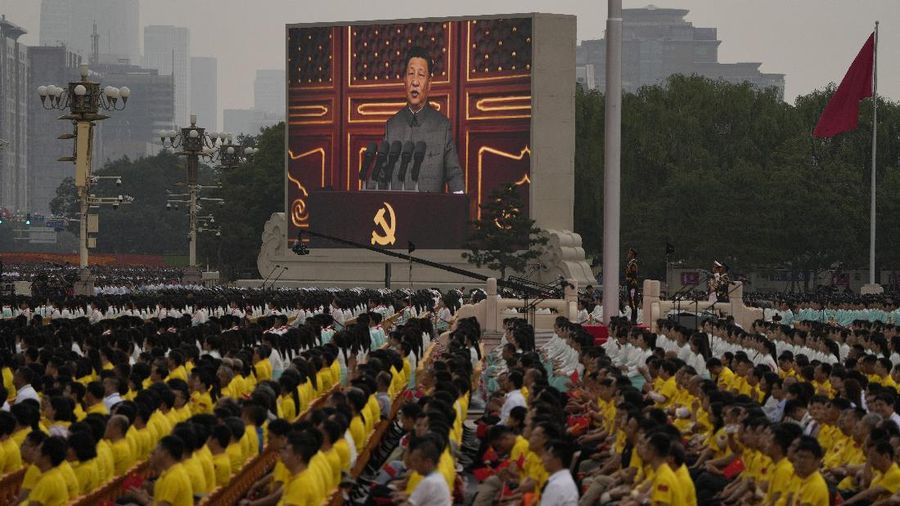 Performers dressed as rescue workers gather around the Communist Party flag during a gala show ahead of the 100th anniversary of the founding of the Chinese Communist Party in Beijing on Monday, June 28, 2021. China is marking the centenary of its ruling Communist Party this week by heralding what it says is its growing influence abroad, along with success in battling corruption at home. (AP Photo/Ng Han Guan)
