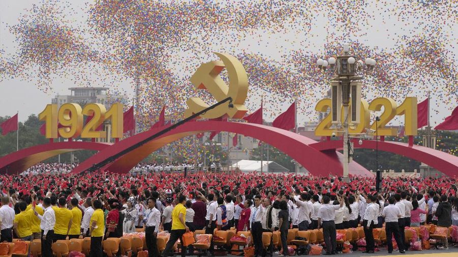 Performers dressed as rescue workers gather around the Communist Party flag during a gala show ahead of the 100th anniversary of the founding of the Chinese Communist Party in Beijing on Monday, June 28, 2021. China is marking the centenary of its ruling Communist Party this week by heralding what it says is its growing influence abroad, along with success in battling corruption at home. (AP Photo/Ng Han Guan)