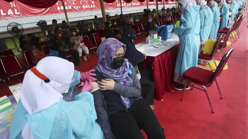 People receive a shot of the Sinovac vaccine for COVID-19 during a vaccination campaign at the Patriot Candrabhaga Stadium in Bekasi on the outskirts of Jakarta, Indonesia, Thursday, July 1, 2021.(AP Photo/Achmad Ibrahim)