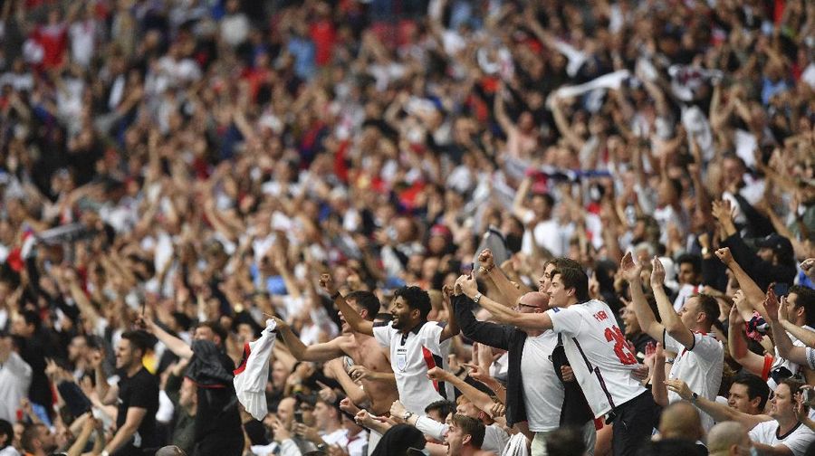 England fans celebrate during the Euro 2020 soccer championship round of 16 match between England and Germany at Wembley Stadium in England, Tuesday June 29, 2021. (Justin Tallis, Pool Photo via AP)
