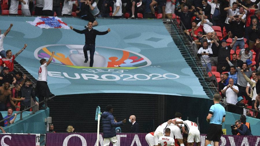 England players and fans celebrate at the end of the Euro 2020 soccer championship round of 16 match between England and Germany at Wembley Stadium in England, Tuesday June 29, 2021. (Justin Tallis, Pool Photo via AP)