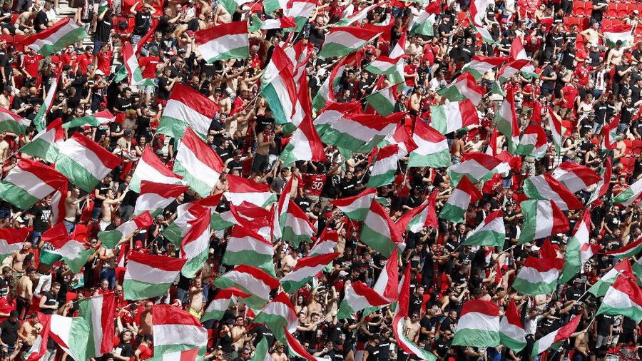Hungary fans wave flags as they wait for the start of the Euro 2020 soccer championship group F match between Hungary and France at the Ferenc Puskas stadium in Budapest, Hungary, Saturday, June 19, 2021. (AP Photo/Laszlo Balogh,Pool)