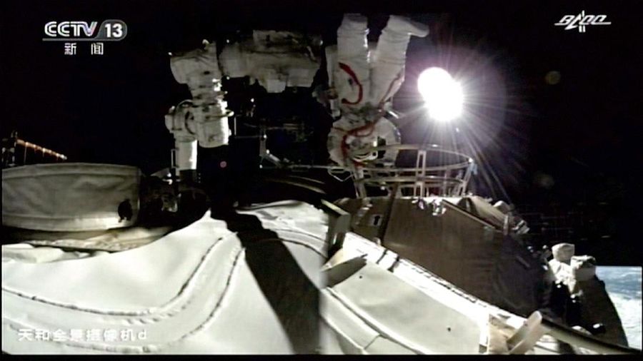This photo released by Xinhua News Agency shows a screen at Beijing Aerospace Control Center showing astronaut Liu Boming stepping out of core module of the China's new space station in space on Sunday, July 4, 2021. Two astronauts made the first space walk on Sunday outside China's new orbital station to work on setting up a 15-meter (50-foot) long robotic arm. (Jin Liwang/Xinhua via AP)